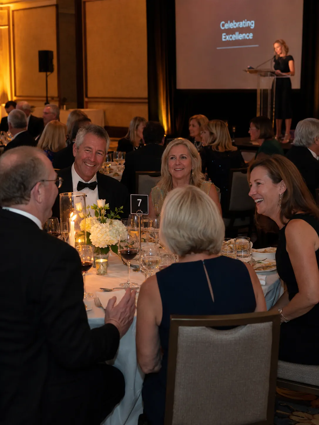 Guests seated at a black-tie association gala dinner