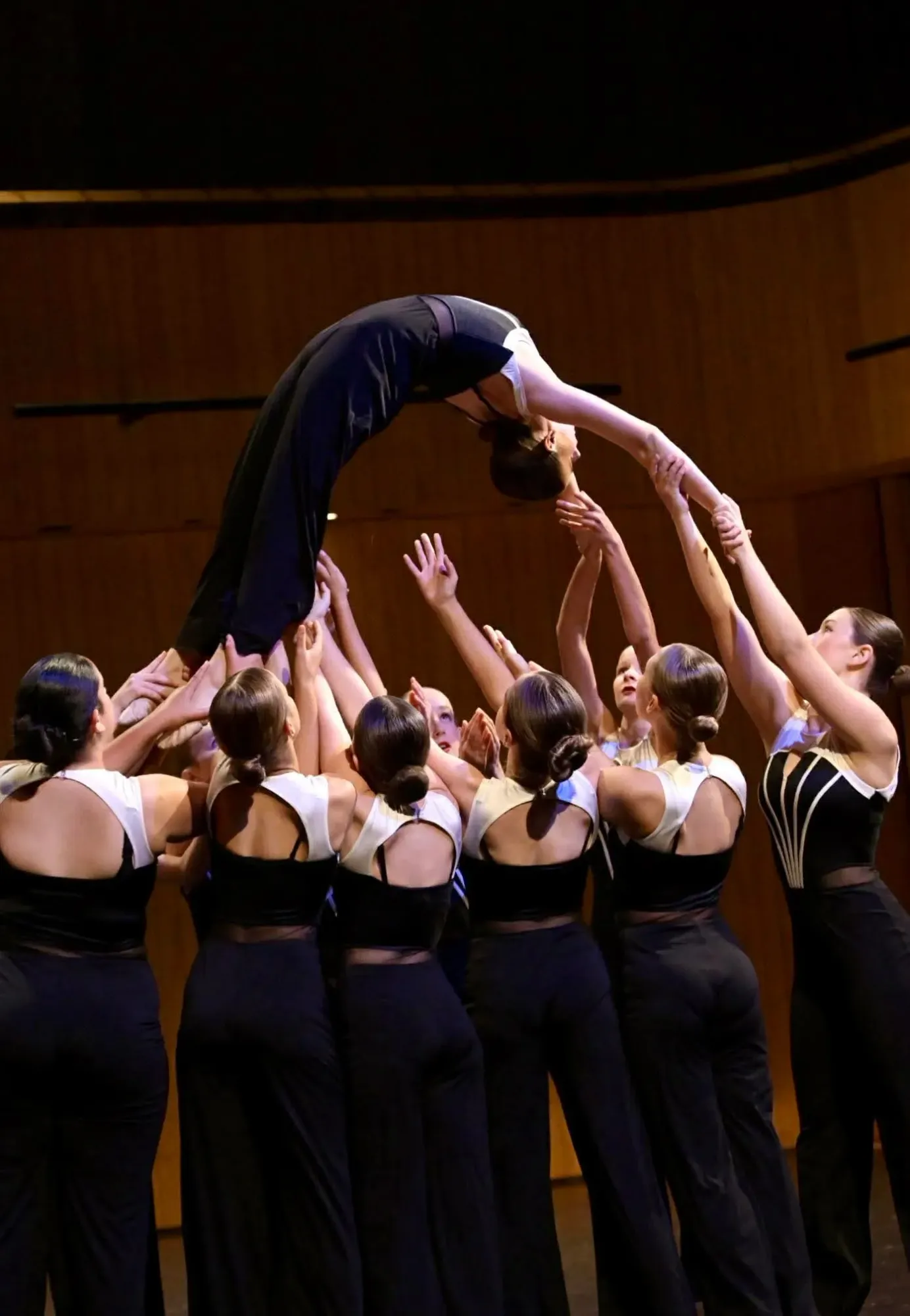 Dancers lifting a performer overhead mid-routine at a DanceForce event in New Zealand