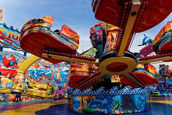 Fairground rides set up on the grounds of a school fete