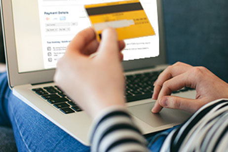 Man at laptop making payment with credit card