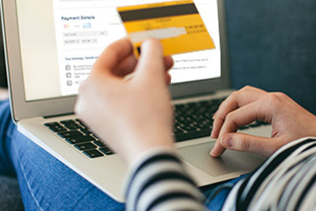Man at laptop making payment with credit card