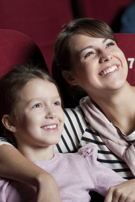 mother and daughter smiling in their cinema seats