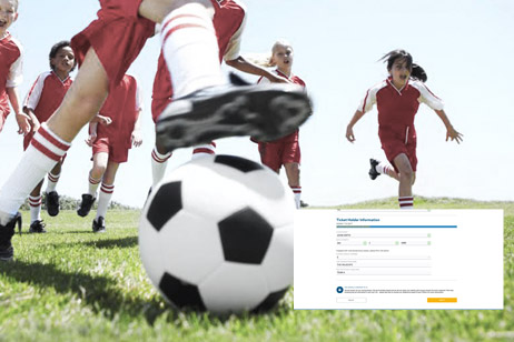 group of kids in soccer uniforms kicking ball