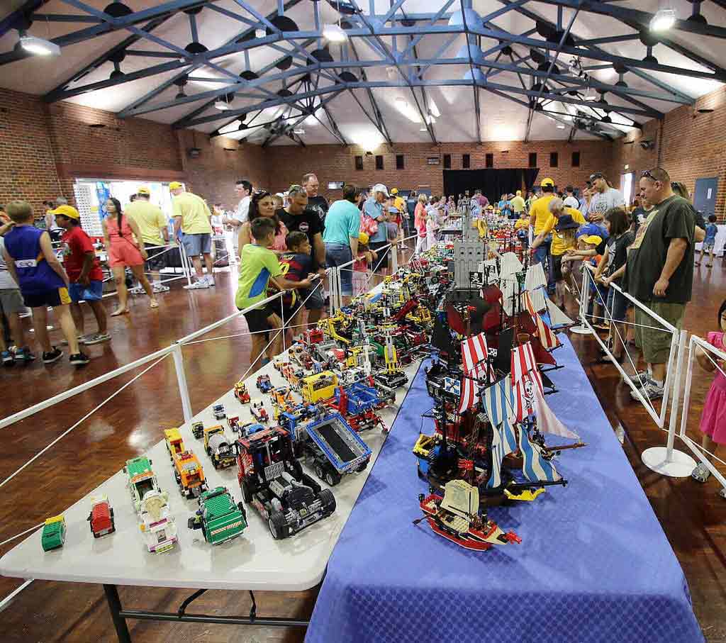 People walking around Bricktober convention looking at lego