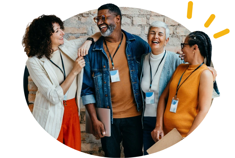 A mixed group of people talking at a community event, with dings in the top right people