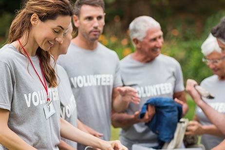 Five volunteers helping at an event