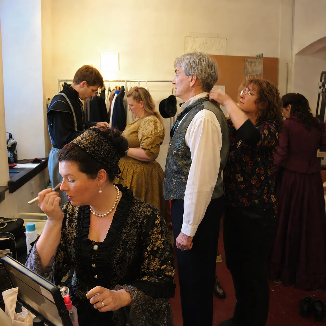 Performers getting ready backstage before a show