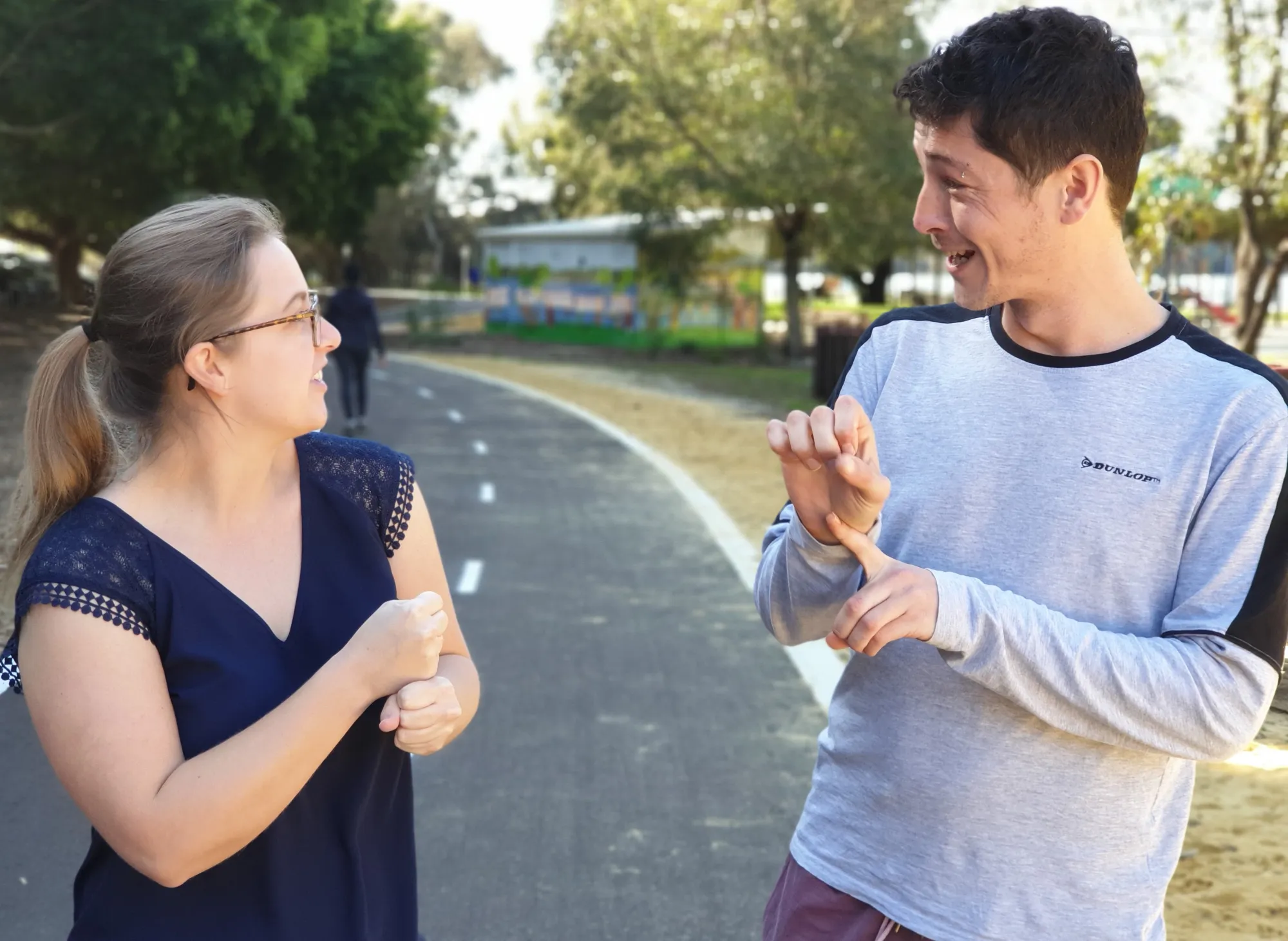 Two people using Auslan sign language during an Access Plus community class