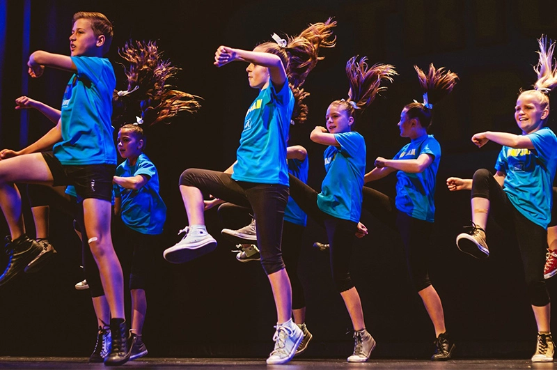 School dance teams performing a Jump Jam routine on stage