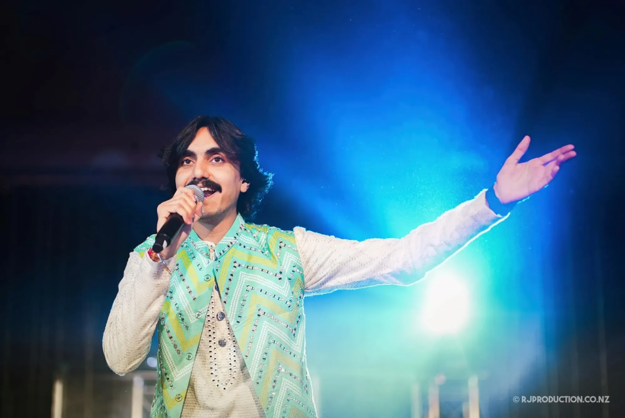 Performers on stage at a Bollywood music concert staged by Pranshi Group