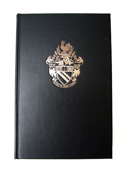 A black book cover with the Bolton School Boys' Division crest embossed in gold: a shield with two diagonal stripes, topped with the crest: a helmet, on top of which a cockerel perches on a bugle, surrounded by mantling. Underneath is the motto: Mutare Vel Timere Sperno